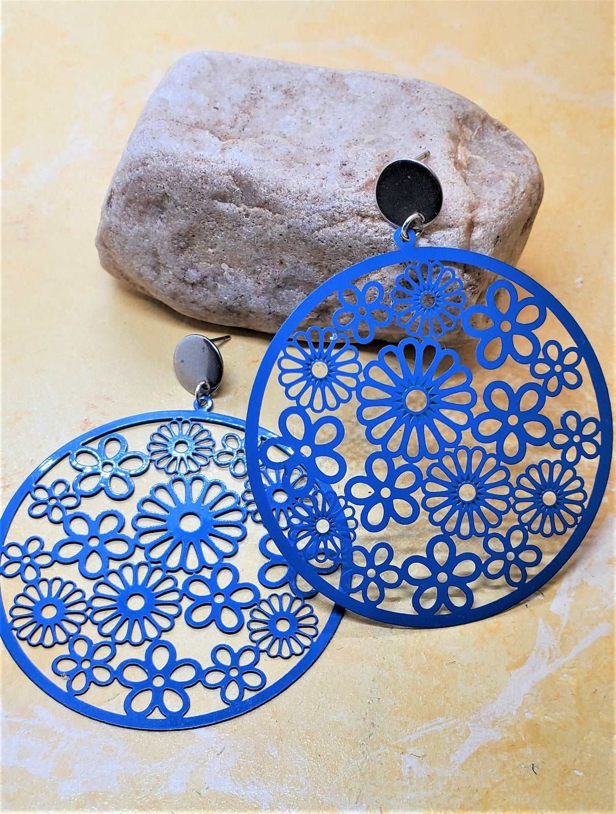 Blue Earrings on a Rock Photo, Flowery Disc Earrings, Earrings for women, earring photography, made by Jiana Deon Brand