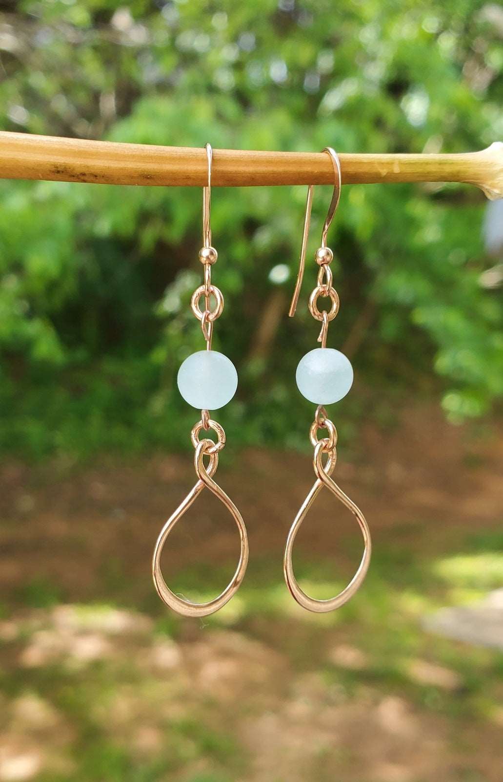 Outdoor photo of women's handmade earrings, Eternity Dangle Earrings, Earrings dangling from branch, Jiana Deon