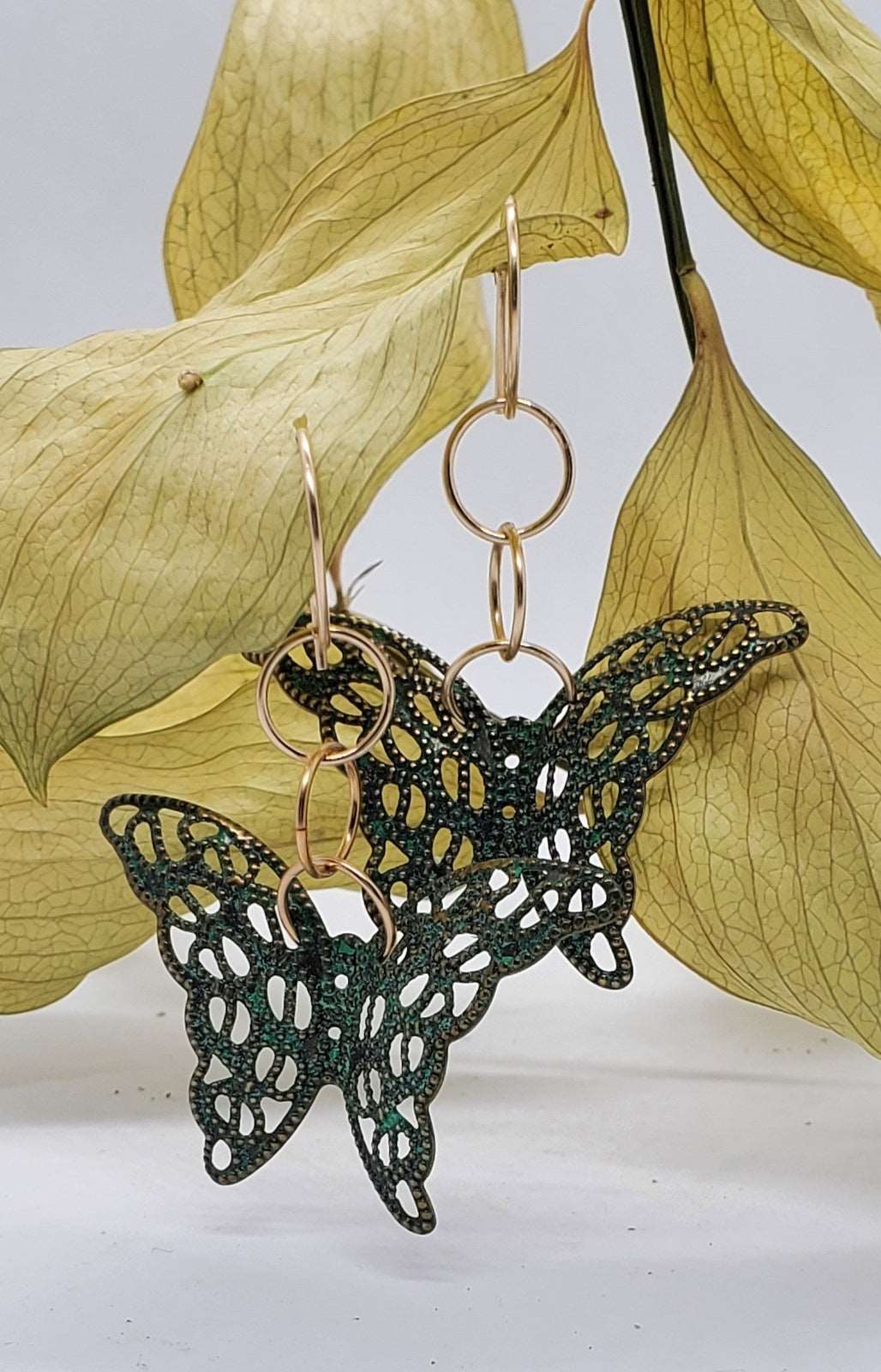 Photo of earrings on leaves, Butterfly Dangle Earrings, handmade earrings, earrings for women, earrings by Jiana Deon