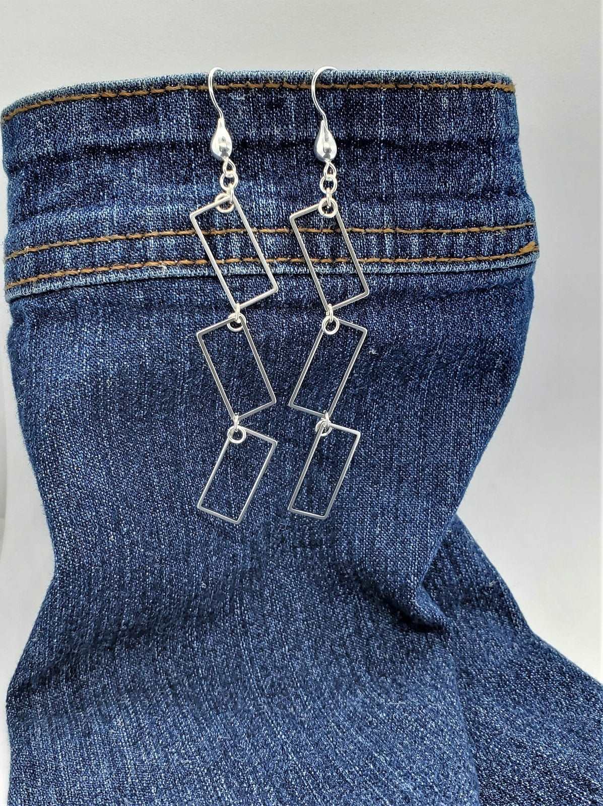Photo of earrings on jeans, handmade earrings, Rectangle Dangle Earrings, earrings by Jiana Deon