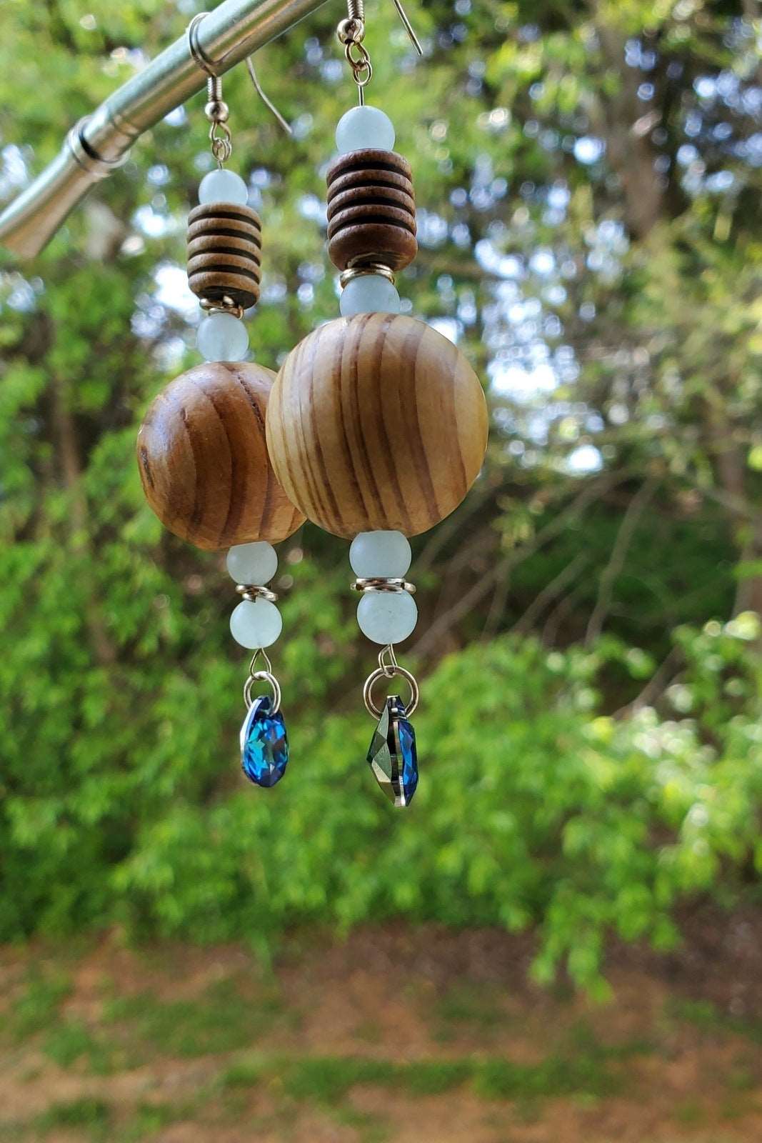 earring handing on metal photo, photo of earrings with outdoor background, wooden earrings for women, handmade earrings, Nina Wooden Bead Earrings